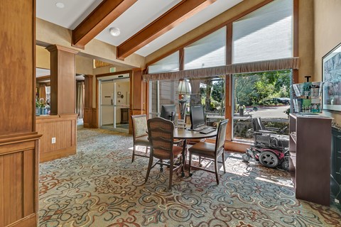 a dining room with a table and chairs and a large window
